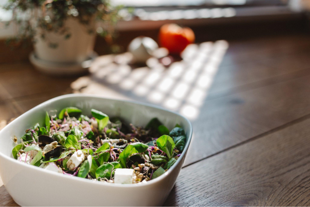 A bowl of salad on a wooden table