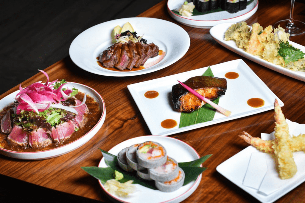 A selection of dishes served at Nobu, including black cod with miso, prawn tempura and sushi