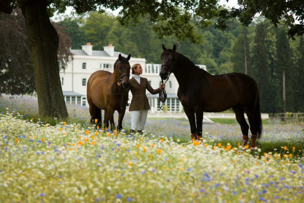 WOman with 2 horses outside of Coworth Park