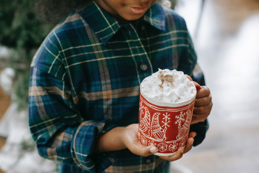 A young boy enjoying a hot chocolate