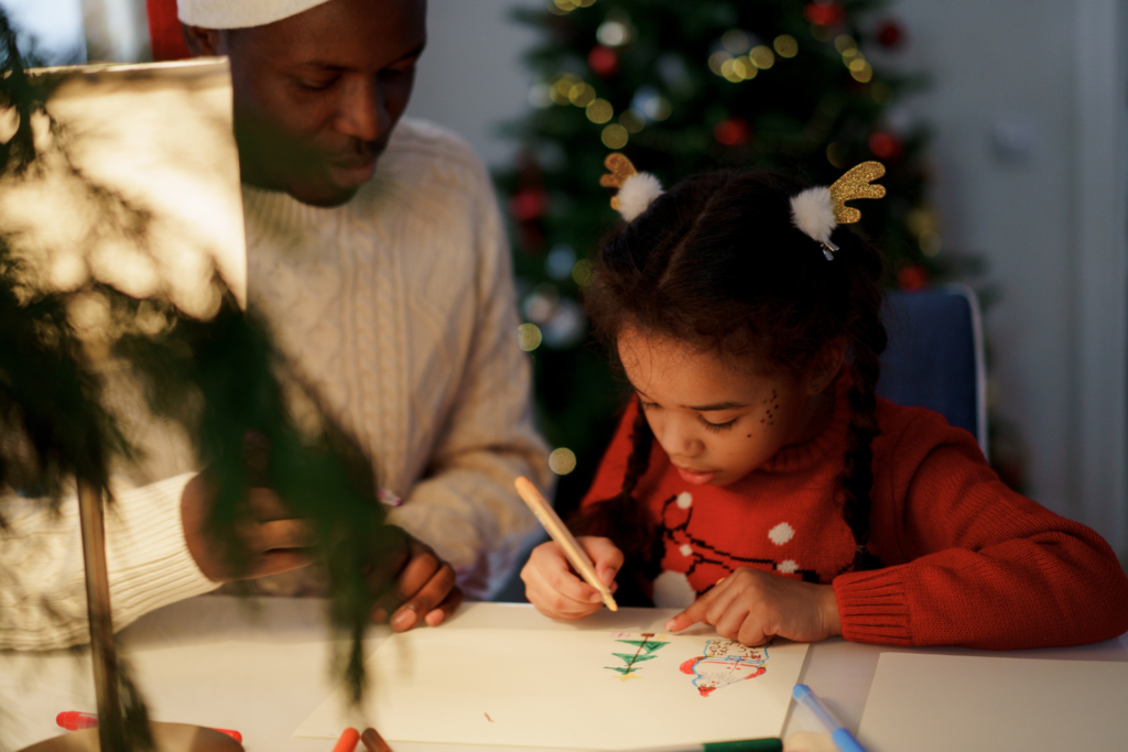 A father and daughter making decorations this festive season