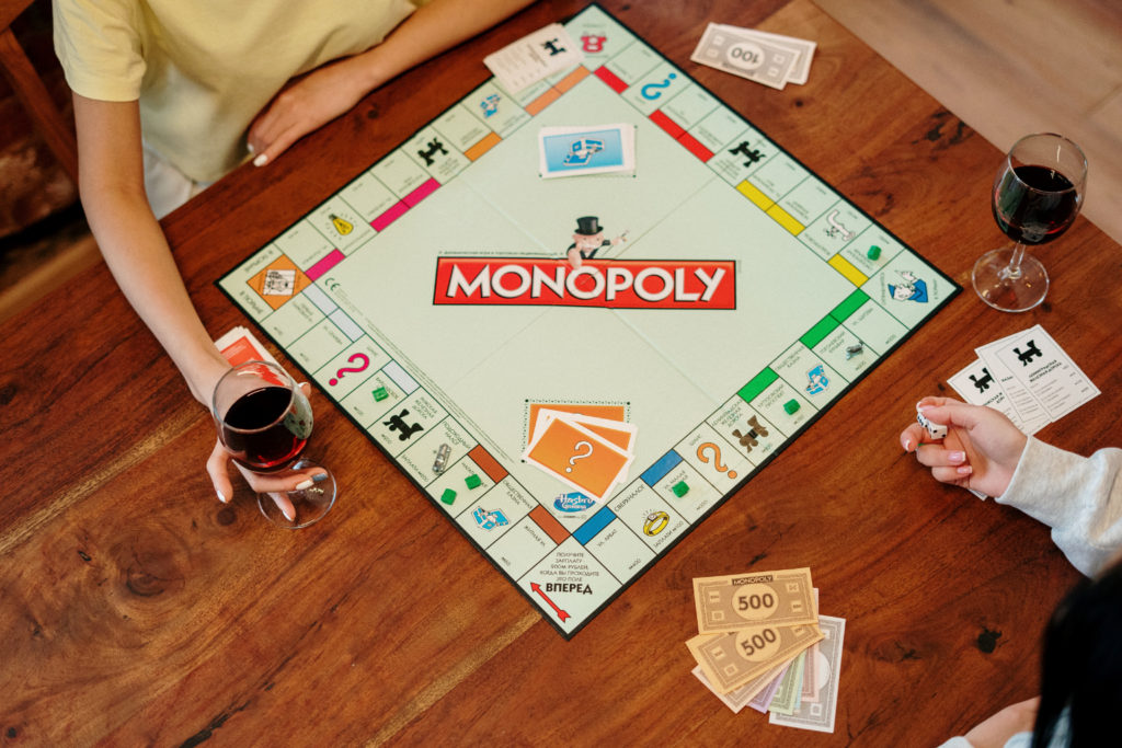 A game of Monopoly being played on a kitchen table