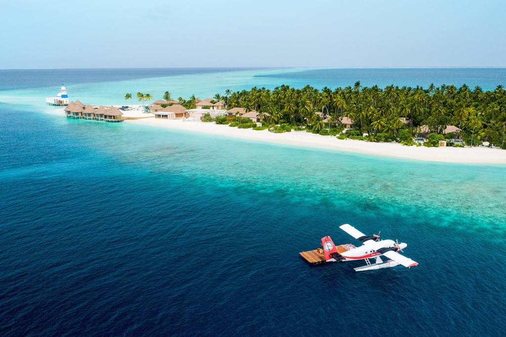 Travel inspiration: a sea plane next to a white sandy beach on the Maldives