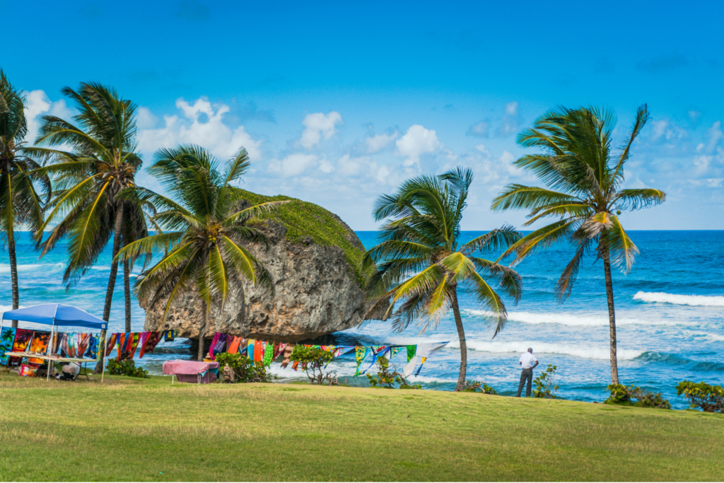 Travel inspiration: a giant boulder in the sea behind colourful laundry in Barbados