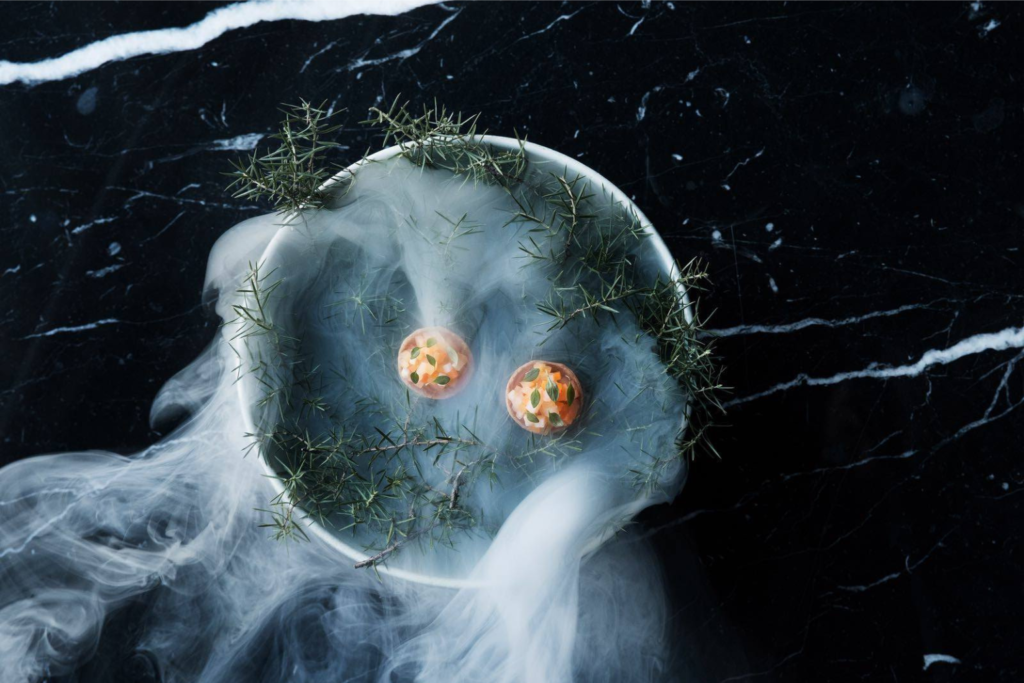 A plate of food from Kontrast served on a bed of rosemary and dry ice