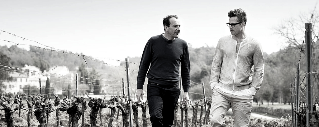 Brad Pitt and Marc Perrin walking through the vineyard of at Château de Beaucastel