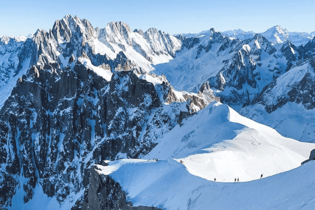 People hiking across snowy mountains