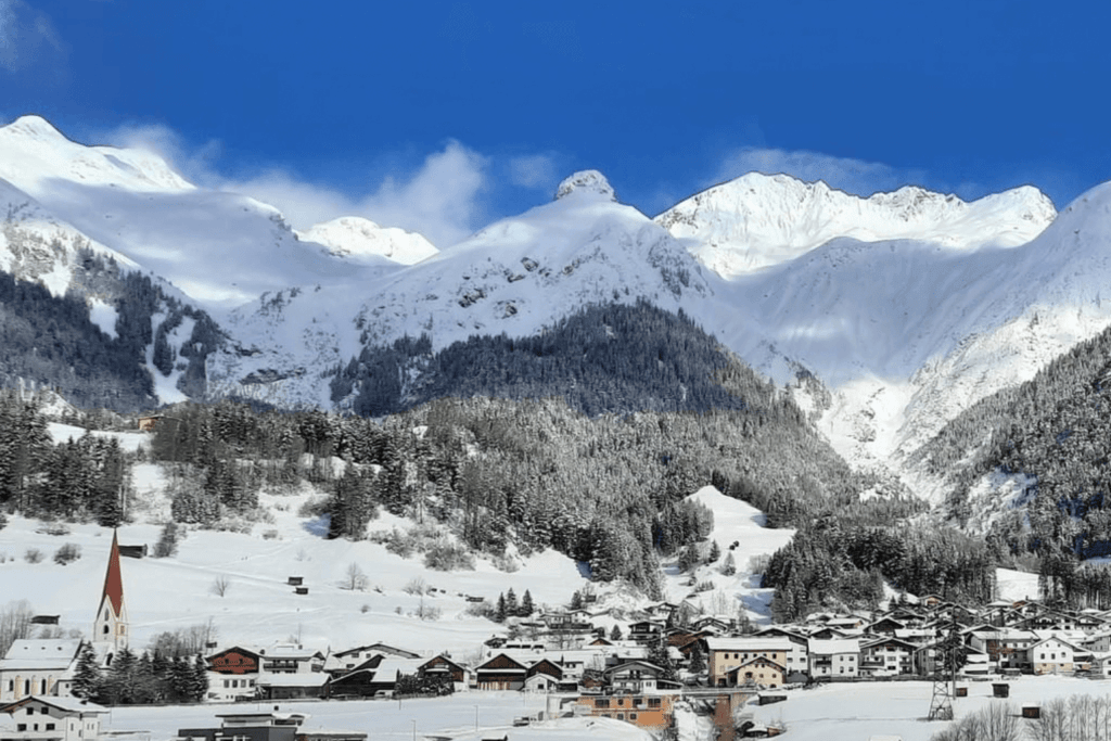 Snow-covered town next to mountains